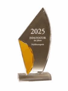 A trophy made of clear glass with a golden accent, engraved with 